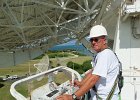 High Work in the Caribbean - Honorable Mention  Dave Vester operates a high reach on the TAA-8 telemetry dish in Antigua.  Photographer: Walter Fenimore, Local Lodge 815, L-3 Communications, Cocoa, FL. : Antigua2011